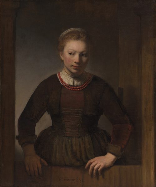 A young woman peers out to the right from from a Dutch door whose bottom half is closed. She wears a brown dress with a corset and a red beaded necklace.